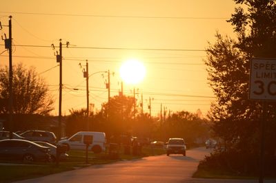 Cars on road at sunset