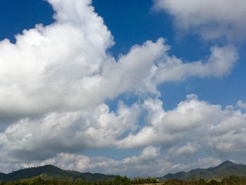 Scenic view of clouds over mountains against sky