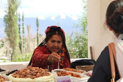 Woman eating food at restaurant