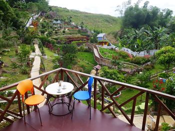 High angle view of railing by trees and plants