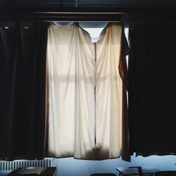 Close-up of clothes hanging on curtain