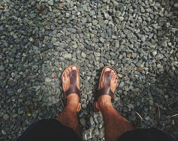 Low section of man standing on rocks