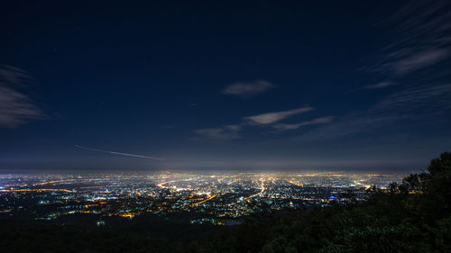 High angle view of illuminated buildings against sky at night