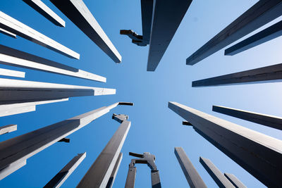 Low angle view of metal artwork against sky