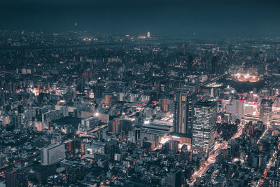 Aerial view of illuminated city against sky at night