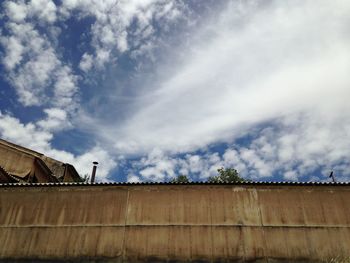 Low angle view of building against cloudy sky