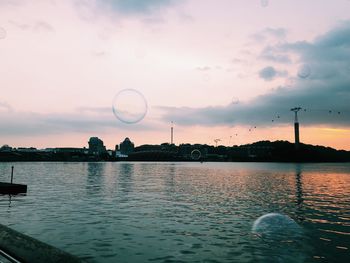 Scenic view of lake against sky at sunset