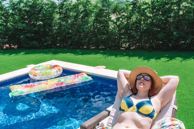 Portrait of young woman swimming in pool