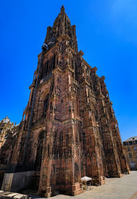 Low angle view of old ruins against clear blue sky