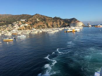 Scenic view of sea and buildings against clear sky