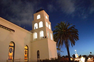 Low angle view of illuminated cathedral against sky at night