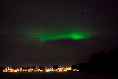 Scenic view of illuminated lights against sky at night