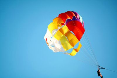 Low angle view of hot air balloon against clear blue sky