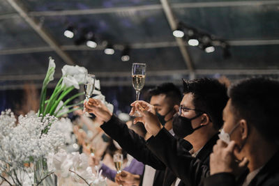 Side view of woman holding bouquet