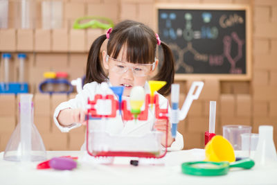 Young girl play science experiments for homeschooling