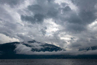 Scenic view of sea against storm clouds