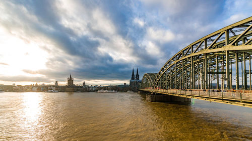 Bridge over river with city in background