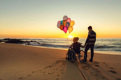 People on beach during sunset