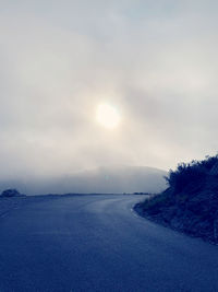 Scenic view of road against sky during winter