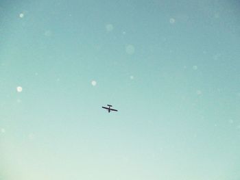 Low angle view of airplane flying in sky