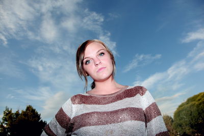 Low angle view of woman standing against clear sky