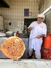 Man working in front of pizza