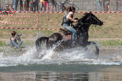 Full length of people splashing water