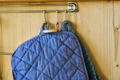 Close-up of blue fabric hanging on hooks