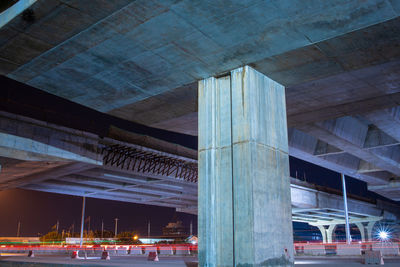 Low angle view of illuminated bridge in city