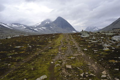 Scenic view of mountains against cloudy sky at jotunheimen national park