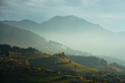 Scenic view of agricultural field and mountains against sky