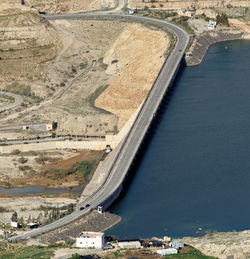 Wadi mujib dam with a road for public transport in jordan, middle east