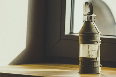 Close-up of glass bottle on table