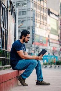 Man sitting on city street