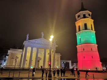 Low angle view of illuminated building against sky at night