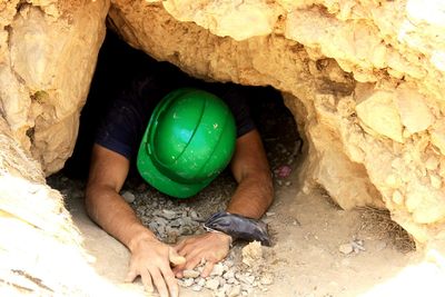 High angle view of man by rock formation .   photo cove , iran cove , gole zard cove