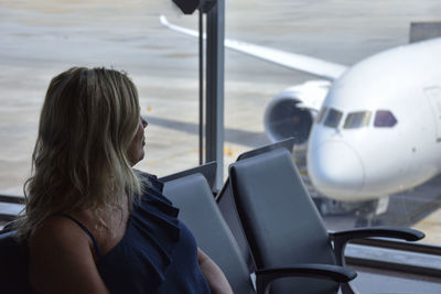 Woman sitting on chair at airport