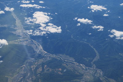 High angle view of land and mountains against sky