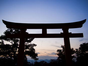 Low angle view of silhouette trees against clear sky