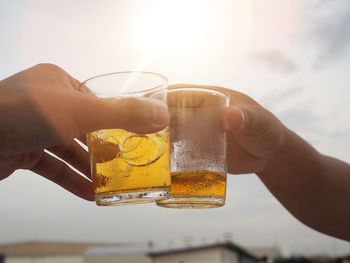 Close-up of hand holding beer glass