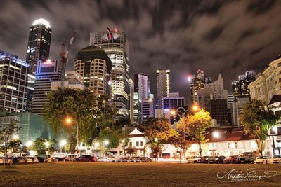 Illuminated cityscape against sky at night