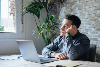 Young man using laptop at office