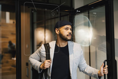 Young businessman leaving office building