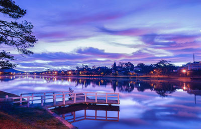 Scenic view of lake against sky at dusk