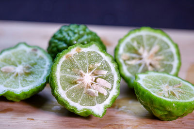 Cut of half bergamot or kaffir lime on cutting board