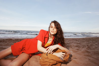 Young woman sitting at beach