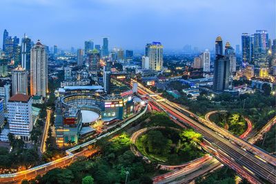 High angle view of illuminated cityscape against sky