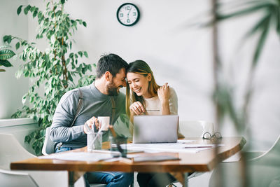 Young couple sitting on table