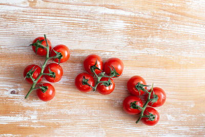 Cherry tomato on light wooden background