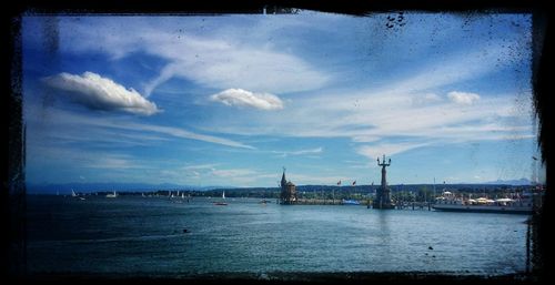 View of harbor against cloudy sky